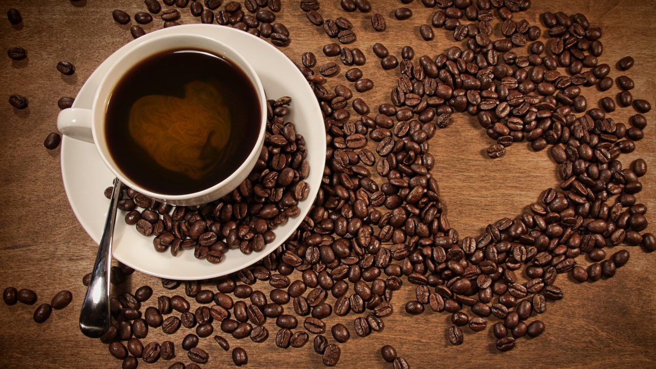A-cup-of-coffee-coffee-beans-placed-heart-shaped-pattern_1920x1080