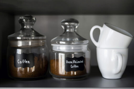 Several types of ground coffee in glass containers are on the shelf. Breakfast coffee concept. Process of making coffee at home