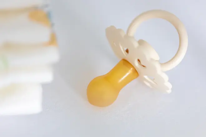 baby-pacifier-diapers-crib-closeup