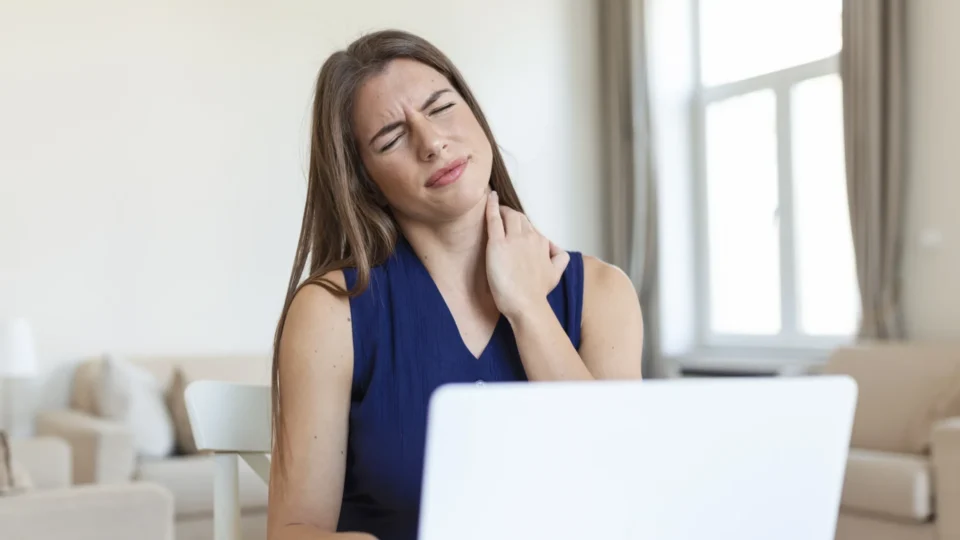 young-businesswoman-suffering-from-neckache-massaging-her-neck-while-sitting-her-working-place-home-office-scaled-960x540