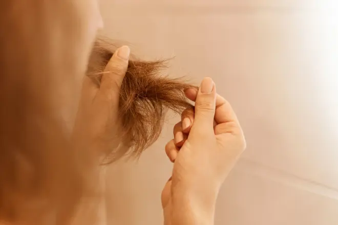closeup-portrait-woman-hands-holding-dry-damaged-hair-eds-having-trichology-problem
